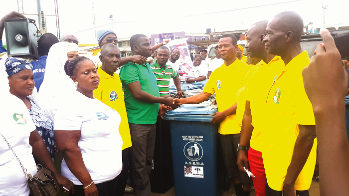 Dr Nuhu (with mic in front of him ) presenting one of the bins to Alhaji Haroun Tetteh Awutu Senya East Assembly steps up sanitation campaign